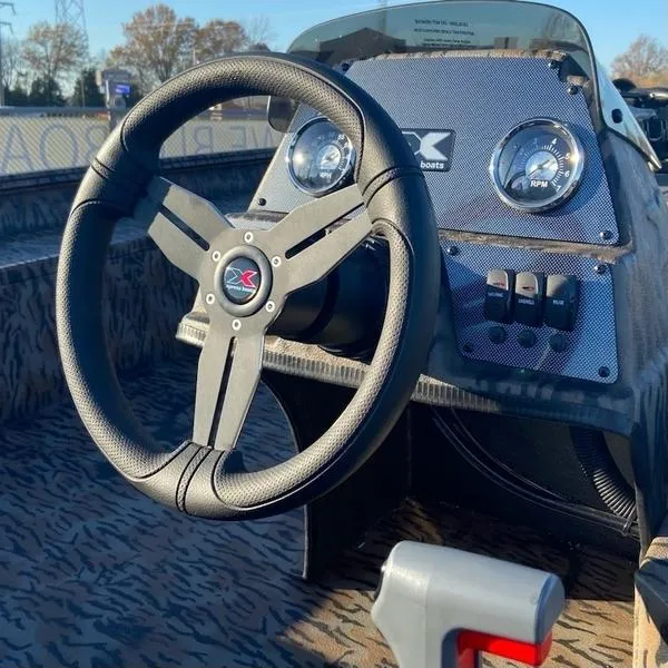 Slide: The Image of 2024 Xpress XP200 boat dashboard with steering wheel and control panel. - 7