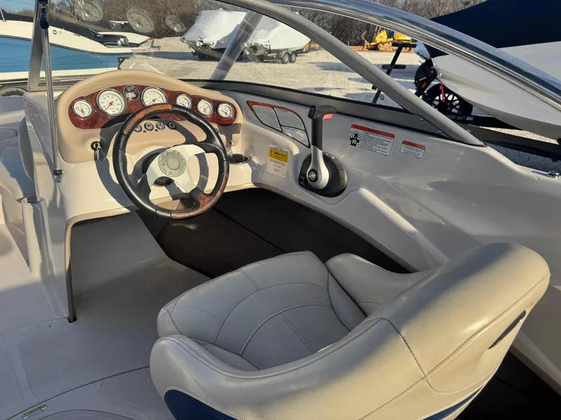 Slide: The Image of 2011 Tracker Tahoe Q5i boat interior with steering wheel and dashboard controls. - 5