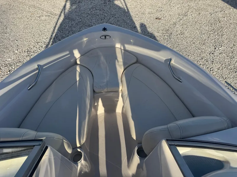 Slide: The Image of 2011 Tracker Tahoe Q5i boat interior with beige seating and metal handles. - 6