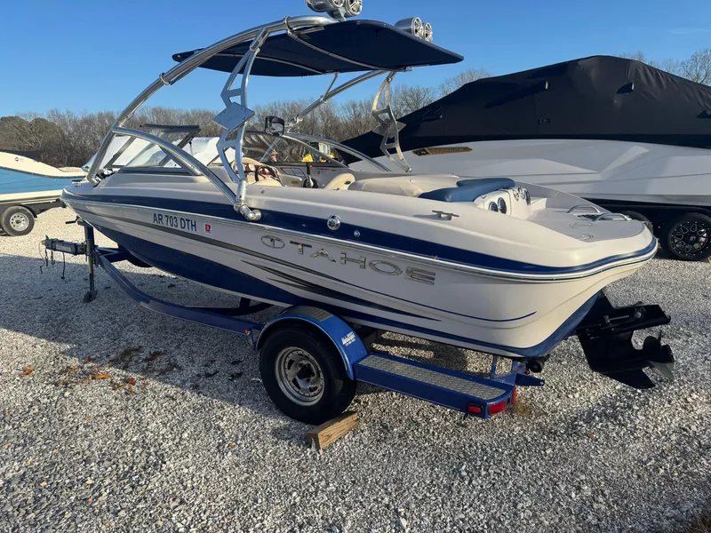 Slide: The Image of 2011 Tracker Tahoe Q5i boat on trailer, parked on gravel lot. - 7