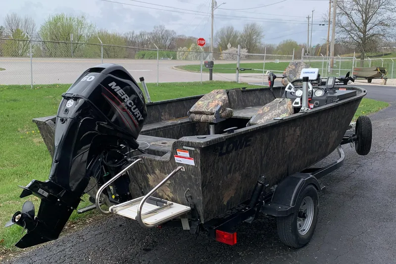 Slide: The Image of 2014 Lowe FM 165 Pro SC fishing boat with Mercury outboard motor on trailer. - 4