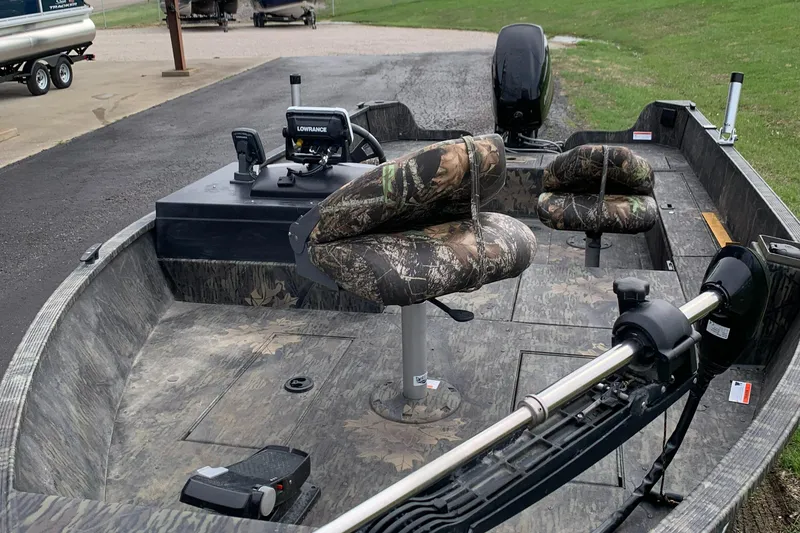 Slide: The Image of 2014 Lowe FM 165 Pro SC fishing boat with camo seats and trolling motor. - 6