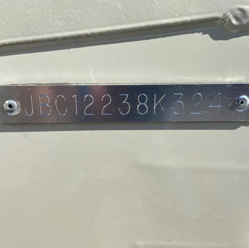 Slide: The Image of 2024 Xpress H18C boat hull identification number JBC12238K324 on metal plate. - 9