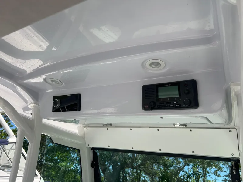 Slide: The Image of 2022 Everglades 273 CC boat interior with electronic controls and overhead panel. - 12