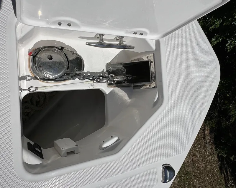 Slide: The Image of Anchor compartment of 2022 Everglades 273 CC boat, featuring chain and winch. - 16