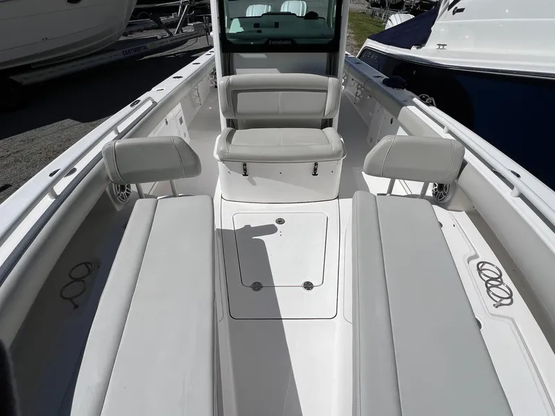 Slide: The Image of 2022 Everglades 273 CC boat interior with white seating and spacious deck layout. - 19