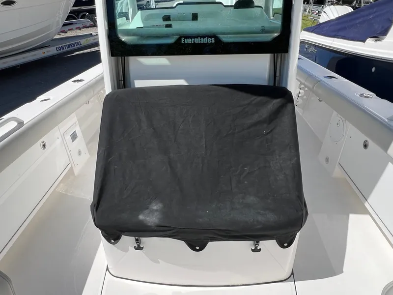 Slide: The Image of 2022 Everglades 273 CC boat with covered seating area on deck. - 22