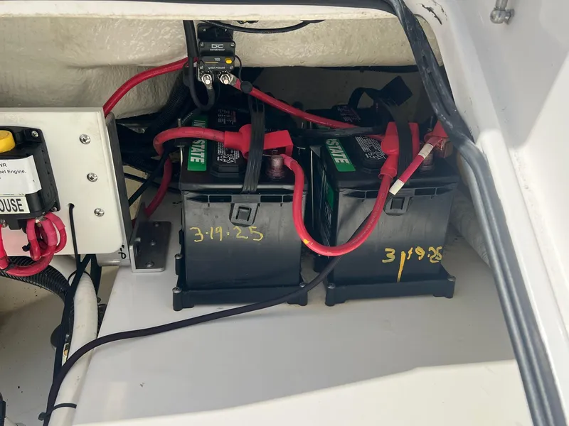 Slide: The Image of Battery compartment of 2022 Everglades 273 CC boat with wiring and connections. - 29