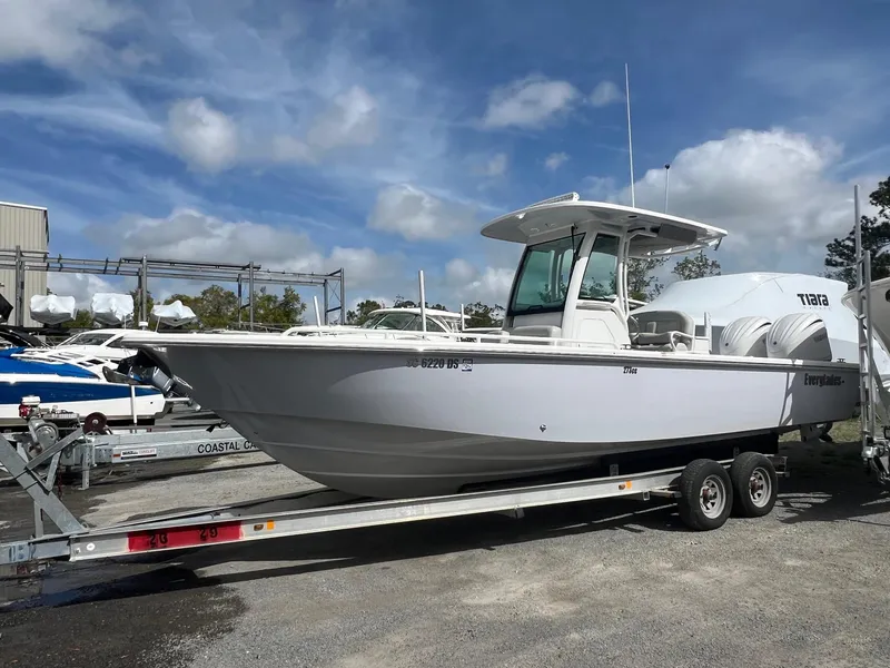 Slide: The Image of 2022 Everglades 273 Center Console boat on trailer under a cloudy sky. - 30