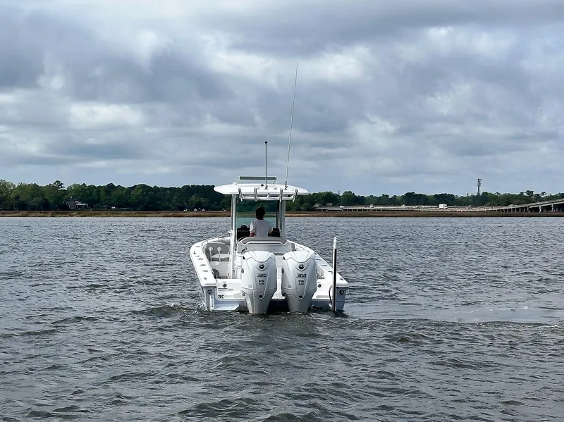 Slide: The Image of 2022 Everglades 273 Center Console boat on open water under cloudy skies. - 5