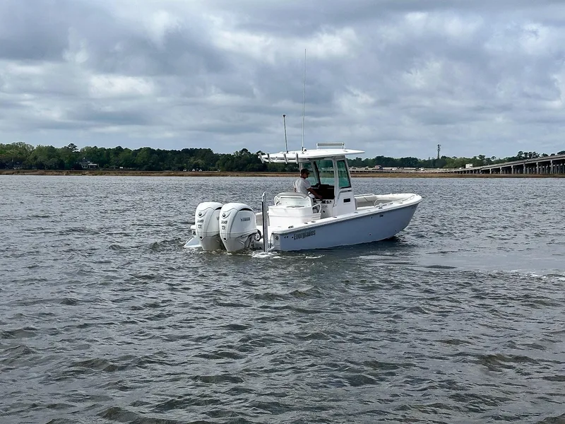 Slide: The Image of 2022 Everglades 273 Center Console boat cruising on a cloudy day. - 6