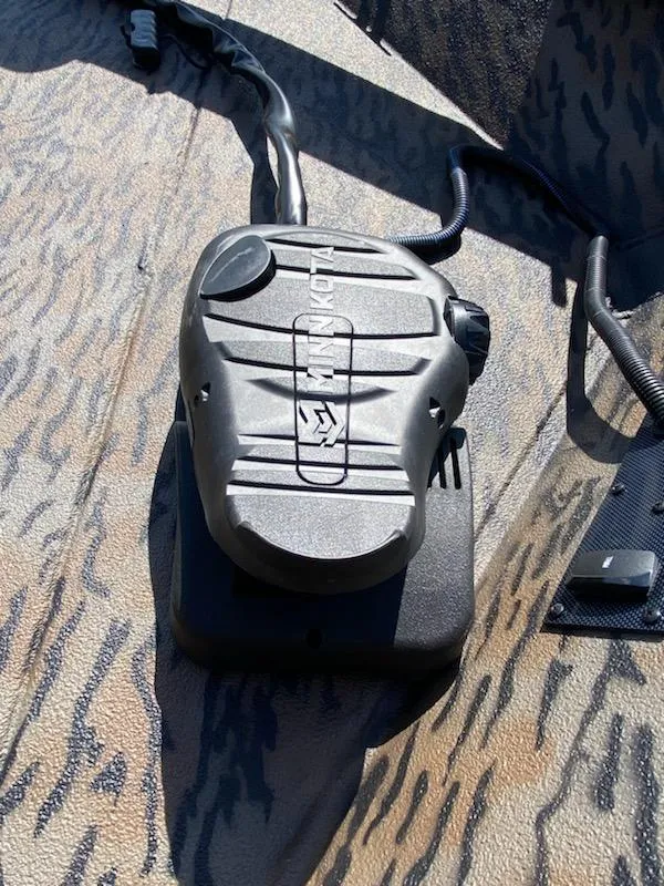 Slide: The Image of 2024 Xpress XP185 Catfish boat interior with camo pattern and control panel. - 12