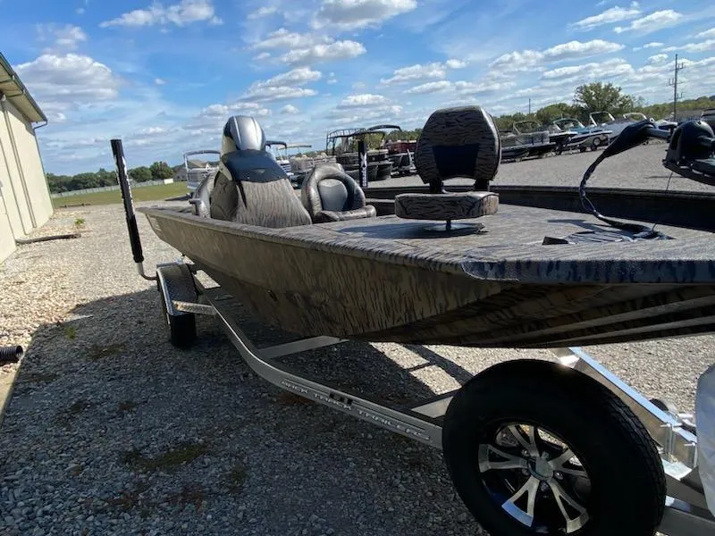 Slide: The Image of 2024 Xpress XP185 Catfish boat on trailer under a clear blue sky. - 16