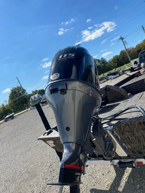Slide: The Image of 2024 Xpress XP185 Catfish boat with powerful 115 engine, parked outdoors under clear blue sky. - 3