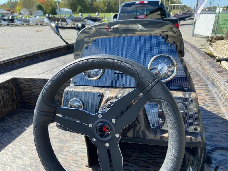 Slide: The Image of 2024 Xpress XP185 Catfish boat dashboard with steering wheel and gauges. - 5