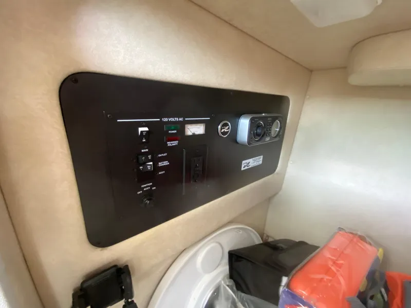 Slide: The Image of Control panel inside 2010 Sea Ray 300 SLX boat cabin, featuring switches and dials. - 10