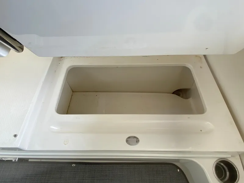 Slide: The Image of Storage compartment on a 2010 Sea Ray 300 SLX boat, open and empty. - 11