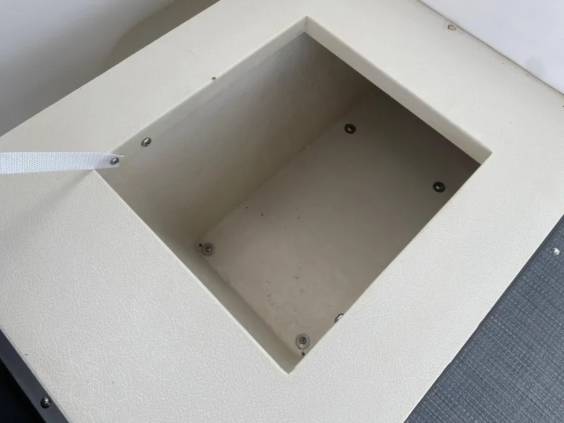 Slide: The Image of Storage compartment on a 2010 Sea Ray 300 SLX boat, featuring a beige interior. - 13