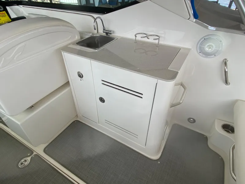 Slide: The Image of 2010 Sea Ray 300 SLX boat interior with sink and storage cabinet. - 15