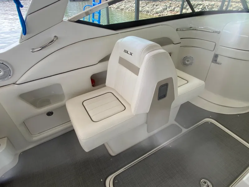 Slide: The Image of Interior of a 2010 Sea Ray 300 SLX boat, featuring white seating and sleek design. - 19