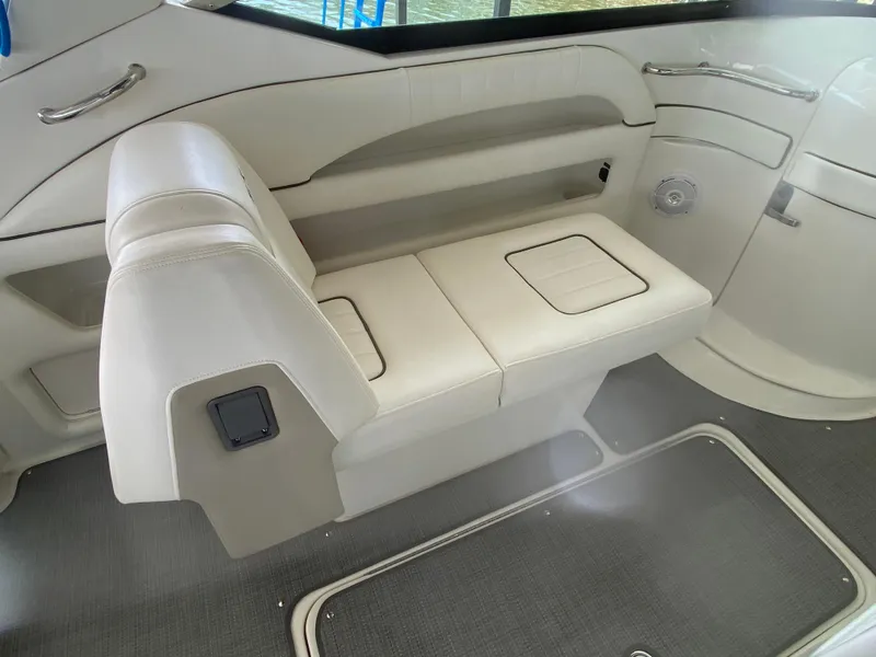 Slide: The Image of 2010 Sea Ray 300 SLX interior seating with white upholstery and storage compartments. - 21