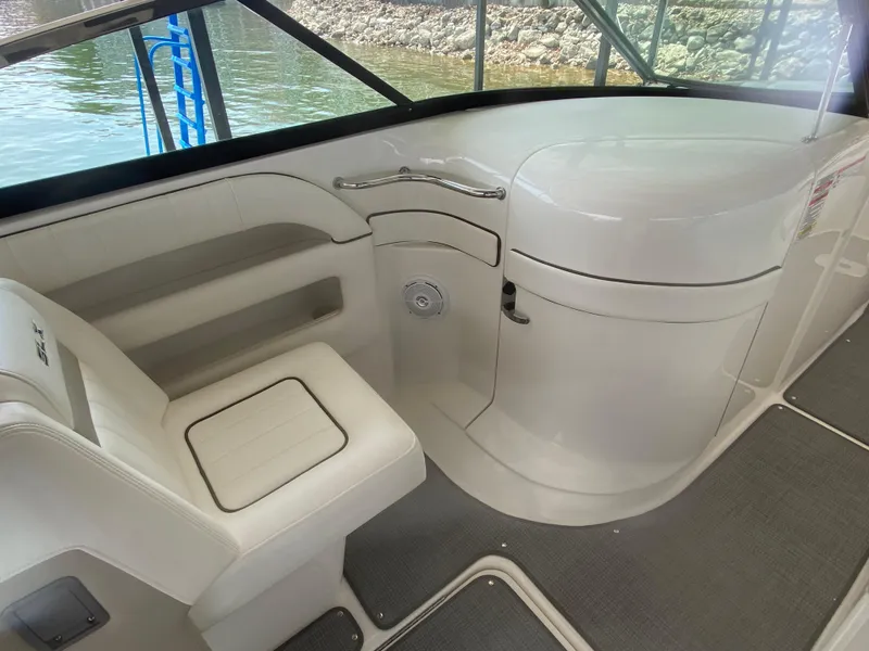Slide: The Image of Interior of a 2010 Sea Ray 300 SLX boat, featuring seating and storage. - 22