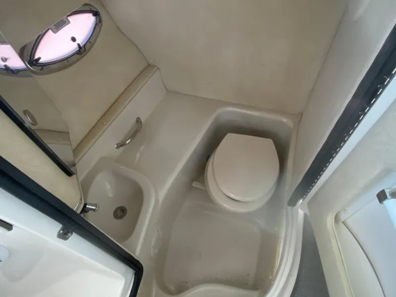 Slide: The Image of 2010 Sea Ray 300 SLX boat bathroom with toilet and sink. - 23