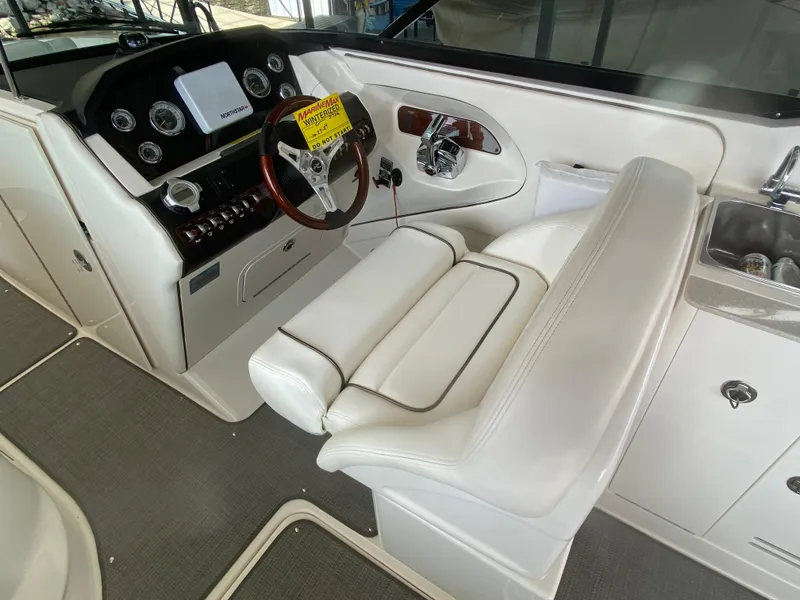 Slide: The Image of 2010 Sea Ray 300 SLX boat interior with white captain's seat and control panel. - 24