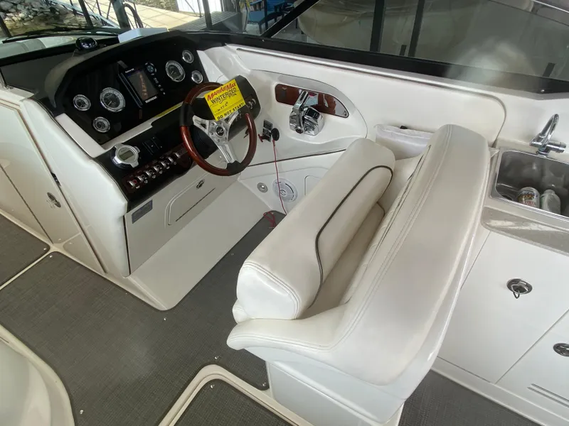 Slide: The Image of 2010 Sea Ray 300 SLX boat interior with steering wheel and control panel. - 25