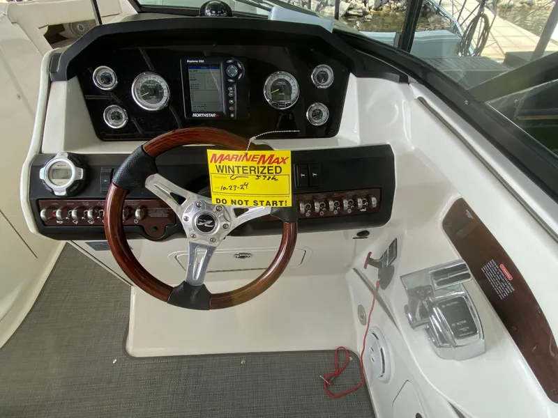 Slide: The Image of Steering console of a 2010 Sea Ray 300 SLX boat with winterization notice. - 26