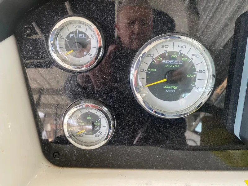 Slide: The Image of Dashboard gauges of a 2010 Sea Ray 300 SLX boat, showing speed and fuel levels. - 29