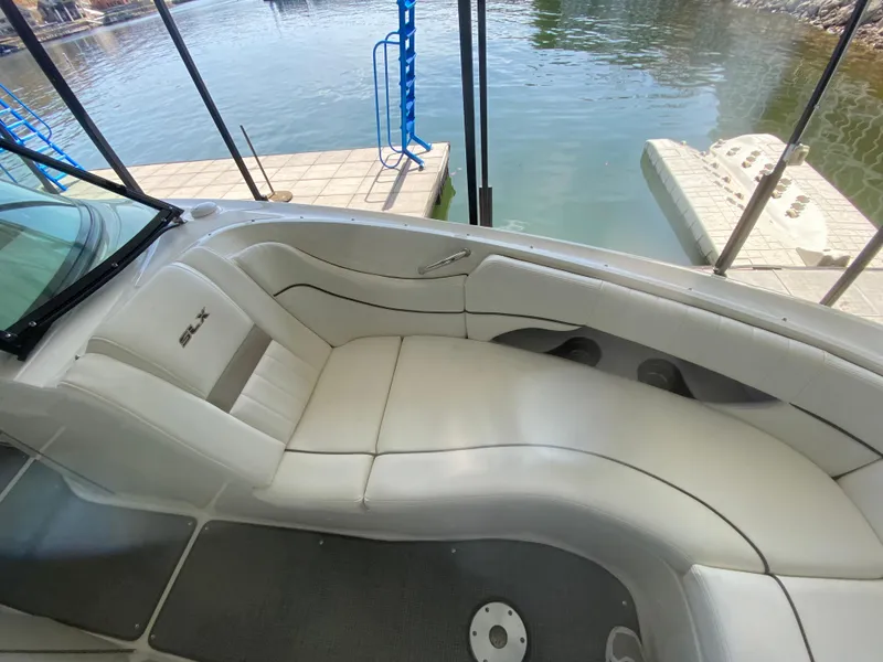 Slide: The Image of 2010 Sea Ray 300 SLX boat interior with white seating by the water. - 37