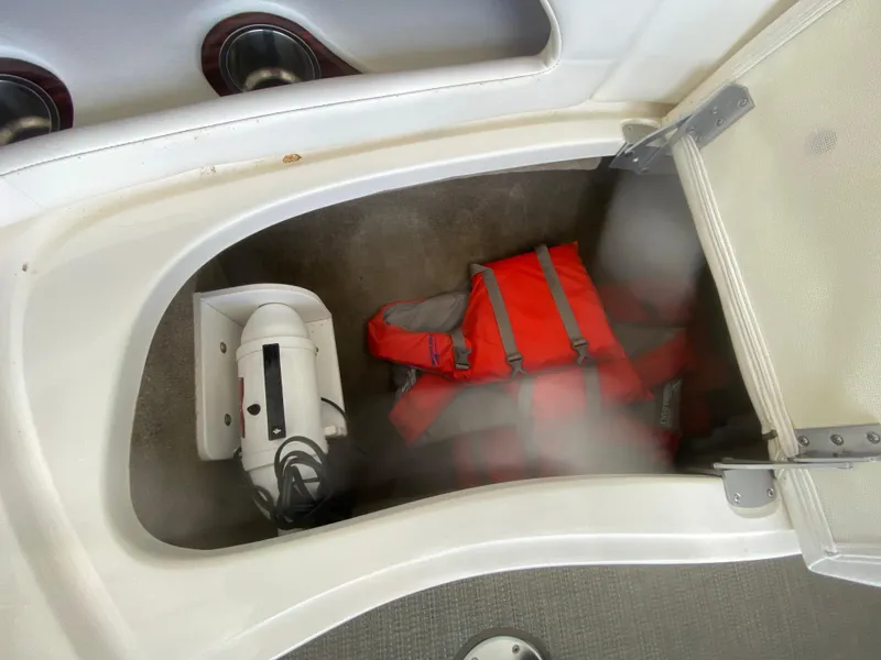 Slide: The Image of Storage compartment in 2010 Sea Ray 300 SLX with life jacket and equipment. - 40