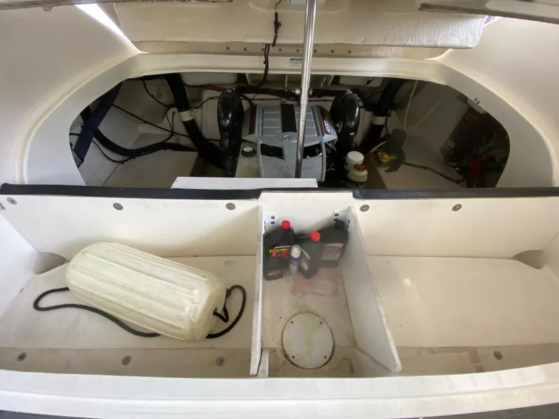 Slide: The Image of Engine compartment of a 2010 Sea Ray 300 SLX boat with maintenance supplies. - 44