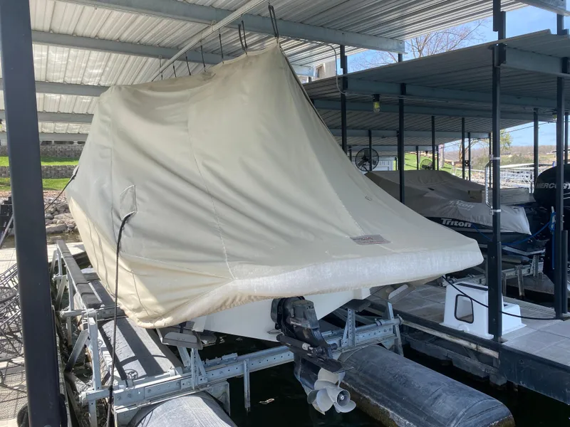 Slide: The Image of Covered 2010 Sea Ray 300 SLX boat docked under a metal canopy. - 47