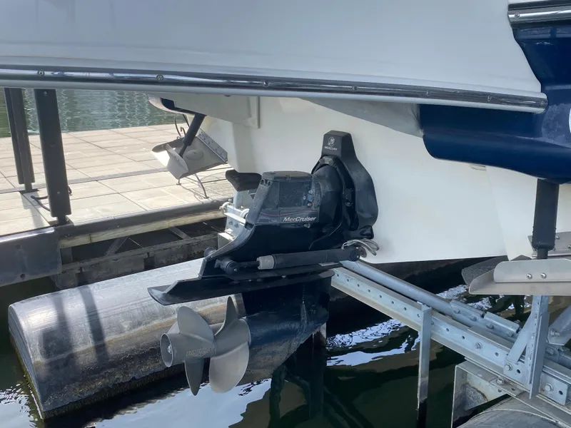 Slide: The Image of 2010 Sea Ray 300 SLX boat on a lift, showcasing the propeller and stern drive. - 6