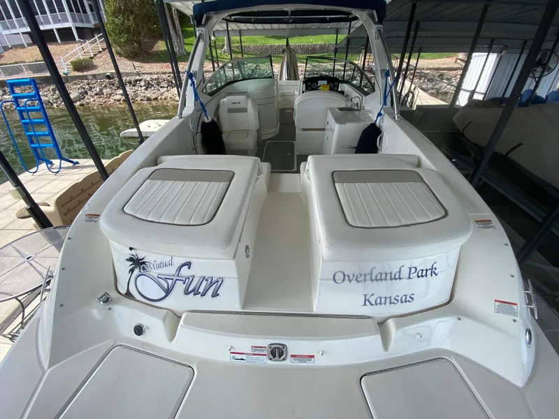 Slide: The Image of 2010 Sea Ray 300 SLX boat docked, featuring spacious seating and custom lettering. - 7