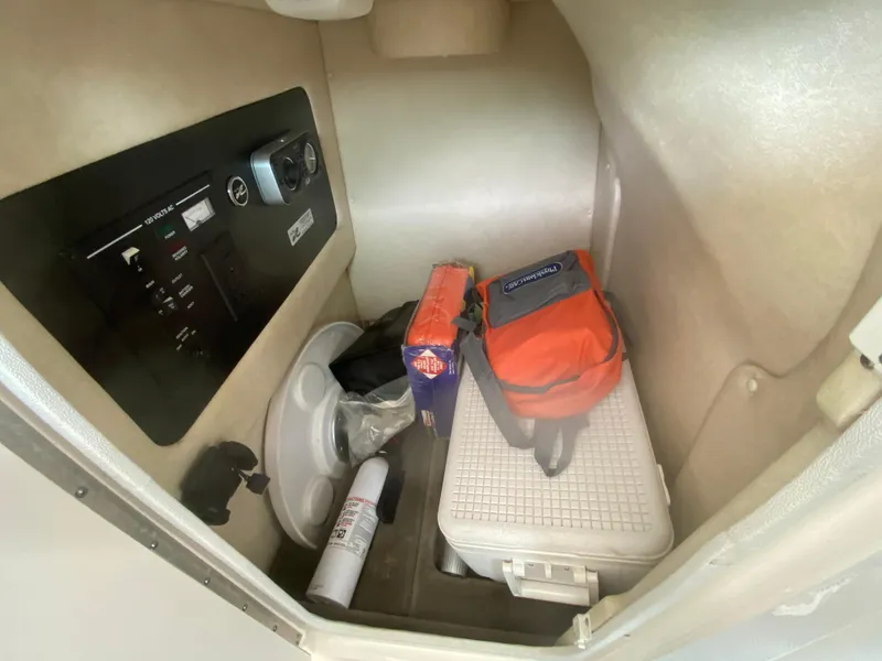 Slide: The Image of Interior storage compartment of a 2010 Sea Ray 300 SLX boat with equipment and supplies. - 9