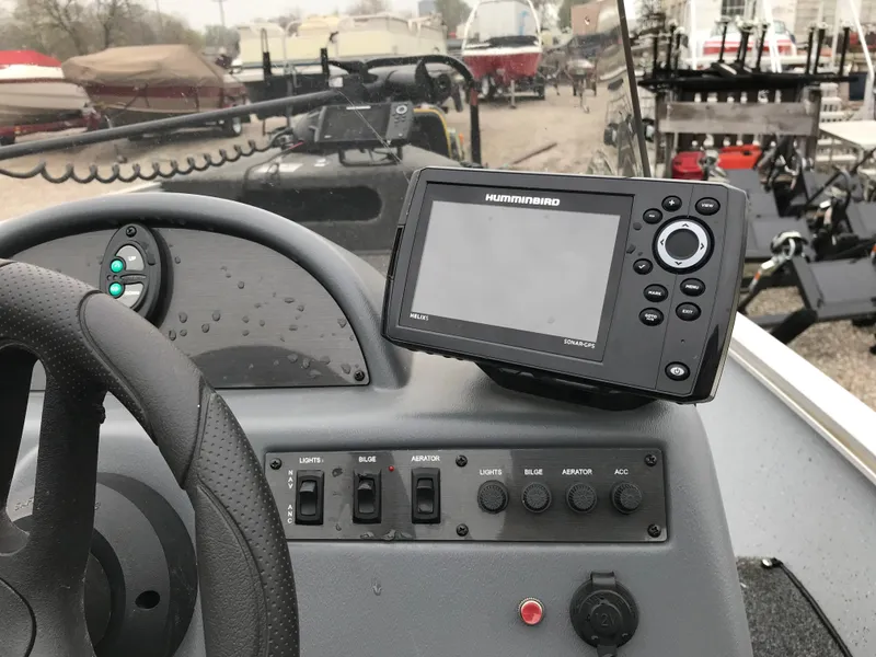 Slide: The Image of 2016 Lund 1600 Rebel SS boat dashboard with Humminbird fish finder and control panel. - 14