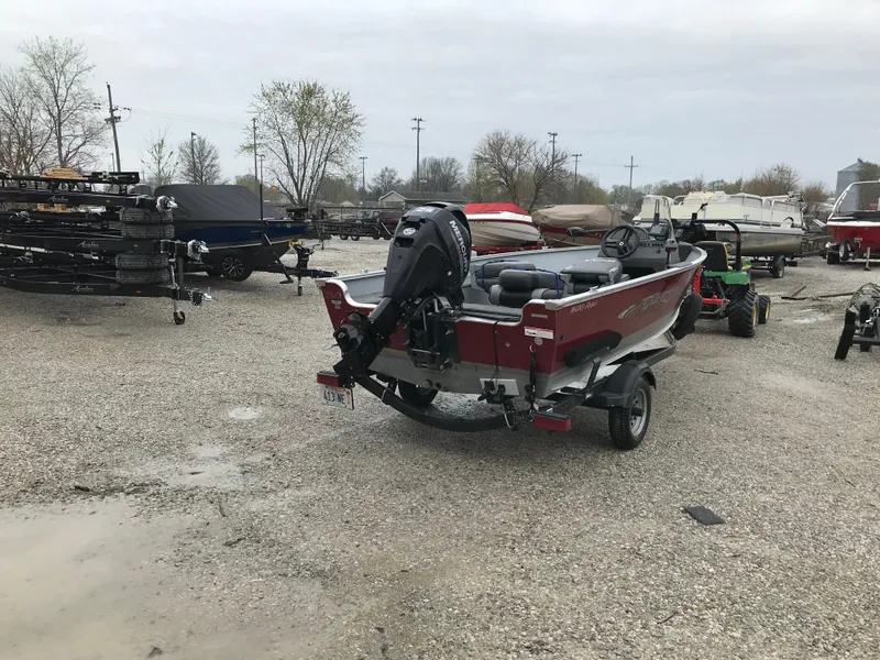 Slide: The Image of 2016 Lund 1600 Rebel SS boat on trailer in a gravel lot. - 4