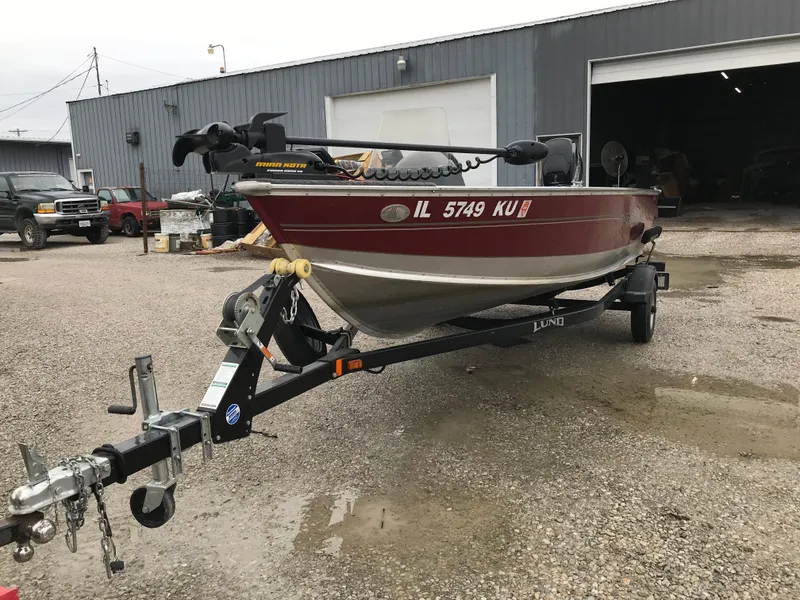Slide: The Image of 2016 Lund 1600 Rebel SS boat on trailer in industrial area. - 7