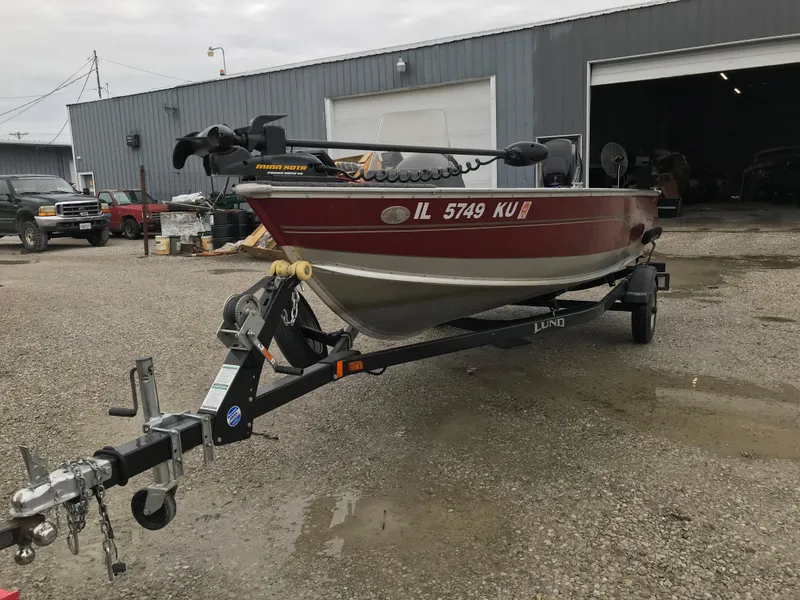 Slide: The Image of 2016 Lund 1600 Rebel SS boat on trailer in industrial setting. - 8