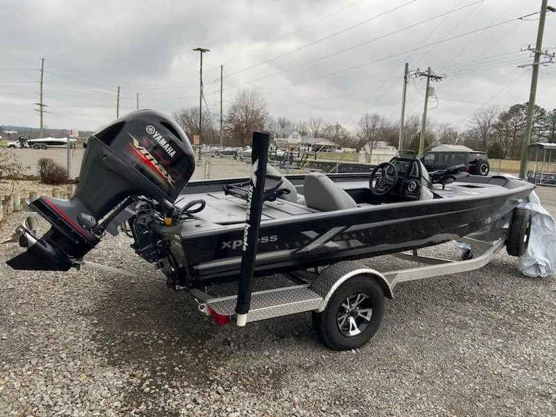 The Image of 2024 Xpress H18C boat with Yamaha engine on a trailer, parked outdoors. - 1