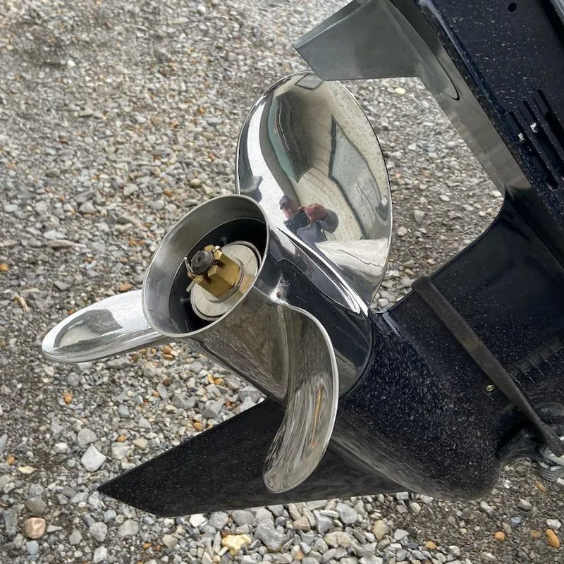 Slide: The Image of 2024 Xpress H18C boat propeller on gravel surface, showcasing shiny metal finish. - 10