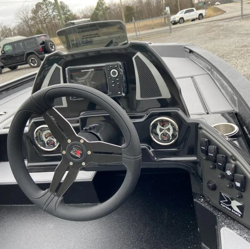Slide: The Image of 2024 Xpress H18C boat dashboard with steering wheel and control panel. - 6