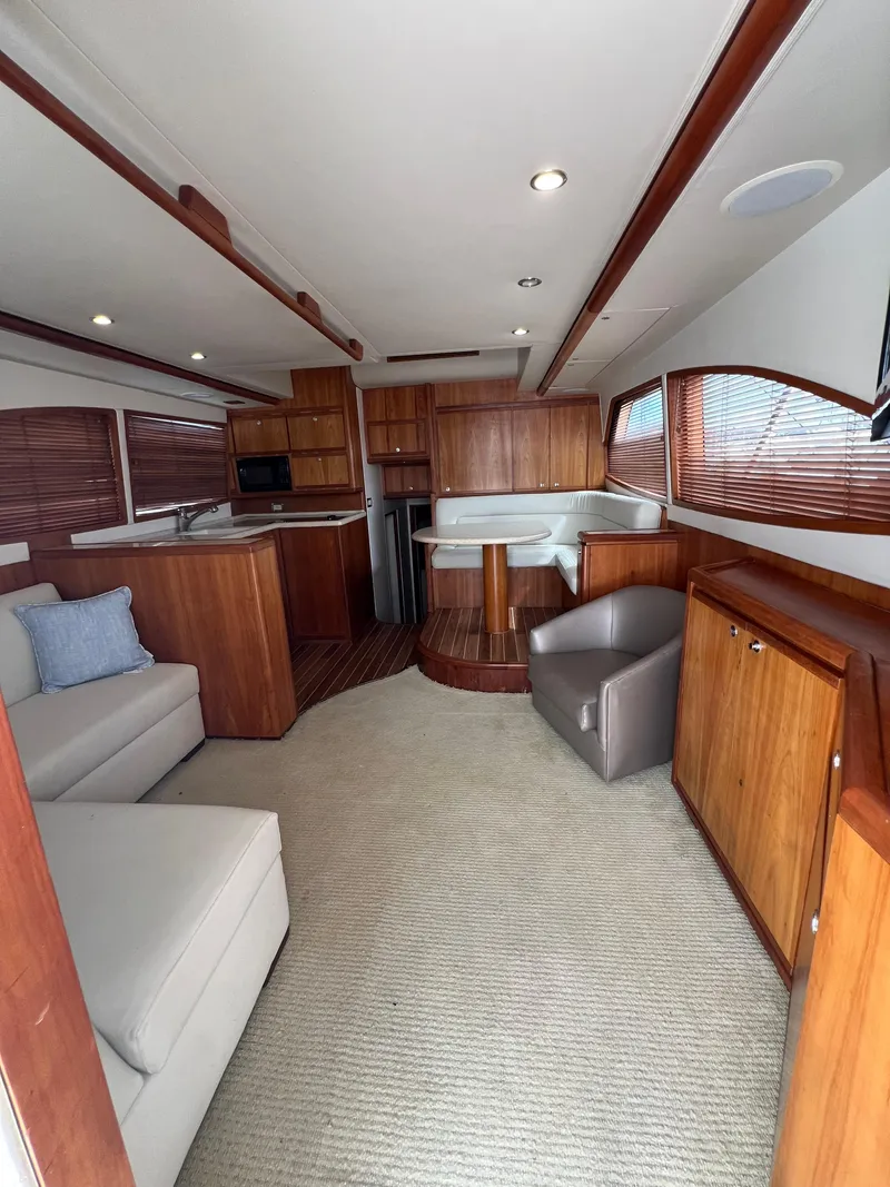 Slide: The Image of Interior of 2009 Bertram 45 Convertible yacht with modern wood finishes and comfortable seating. - 11