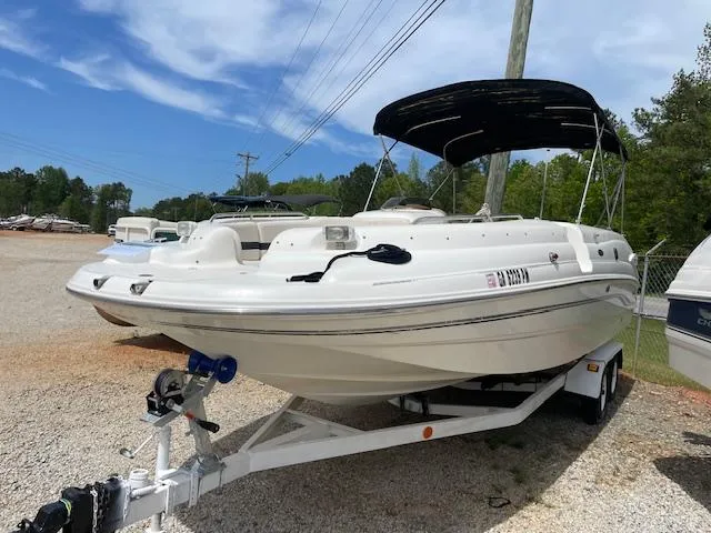 Slide: The Image of 2000 Chaparral Sunesta 232 boat on trailer, parked outdoors under a clear sky. - 1