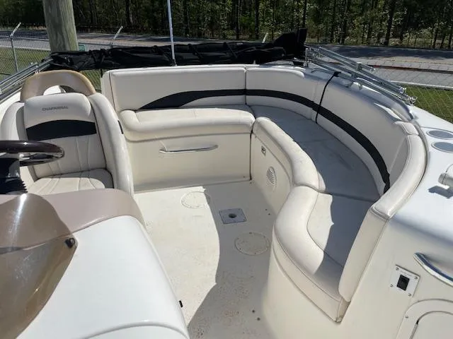 Slide: The Image of 2000 Chaparral Sunesta 232 boat interior with white seating and steering wheel. - 11
