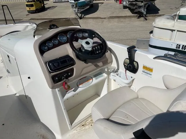 Slide: The Image of Cockpit of 2000 Chaparral Sunesta 232 boat with steering wheel and control panel. - 12