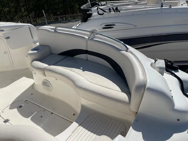 Slide: The Image of 2000 Chaparral Sunesta 232 boat interior with white seating and speaker. - 6